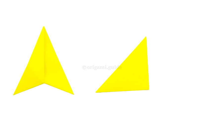 10. Fold the right point over to the left point. You may want to stick the flaps of the triangle together.