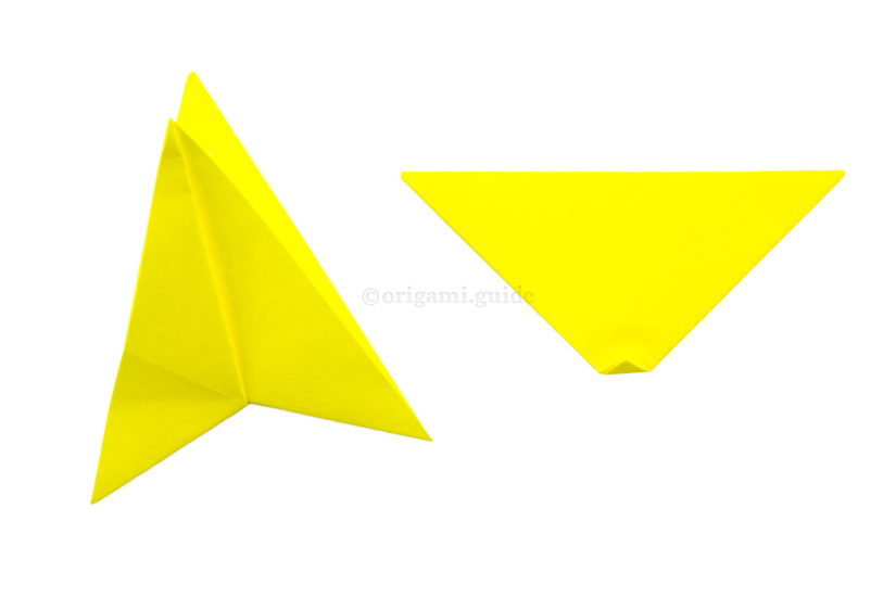 11. Rotate the triangle. You can fold the bottom point up a tiny bit, to make the star a more symmetrical shape. Open the first star shape.