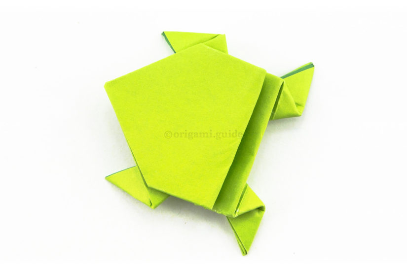 25. The origami frog is complete, use your finger and hold the back edge down and the frog will spring up and away.