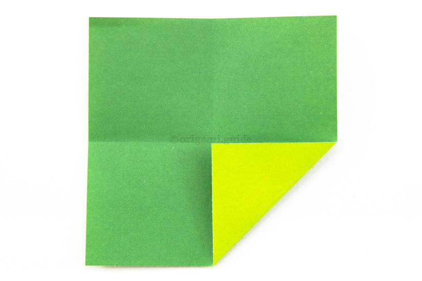6. Fold one corner to the center of the paper.