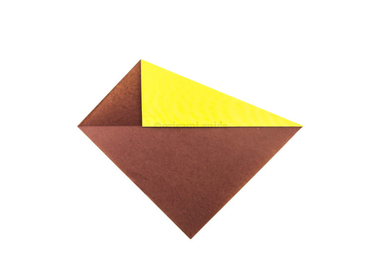 4. Take the top right diagonal edge and fold it down, aligning with the crease you made in step 2.