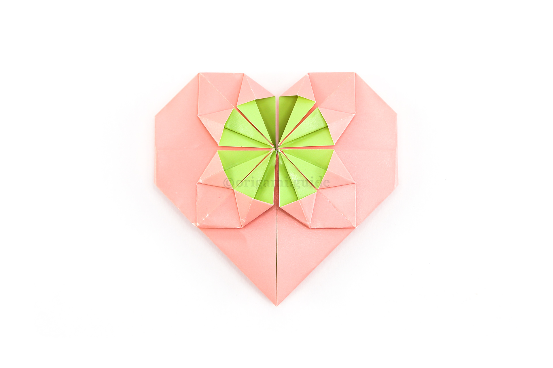 32. The fancy origami heart is complete! If you're adding coin to the middle circle, it will fit under the four "spikes" inside the circle.