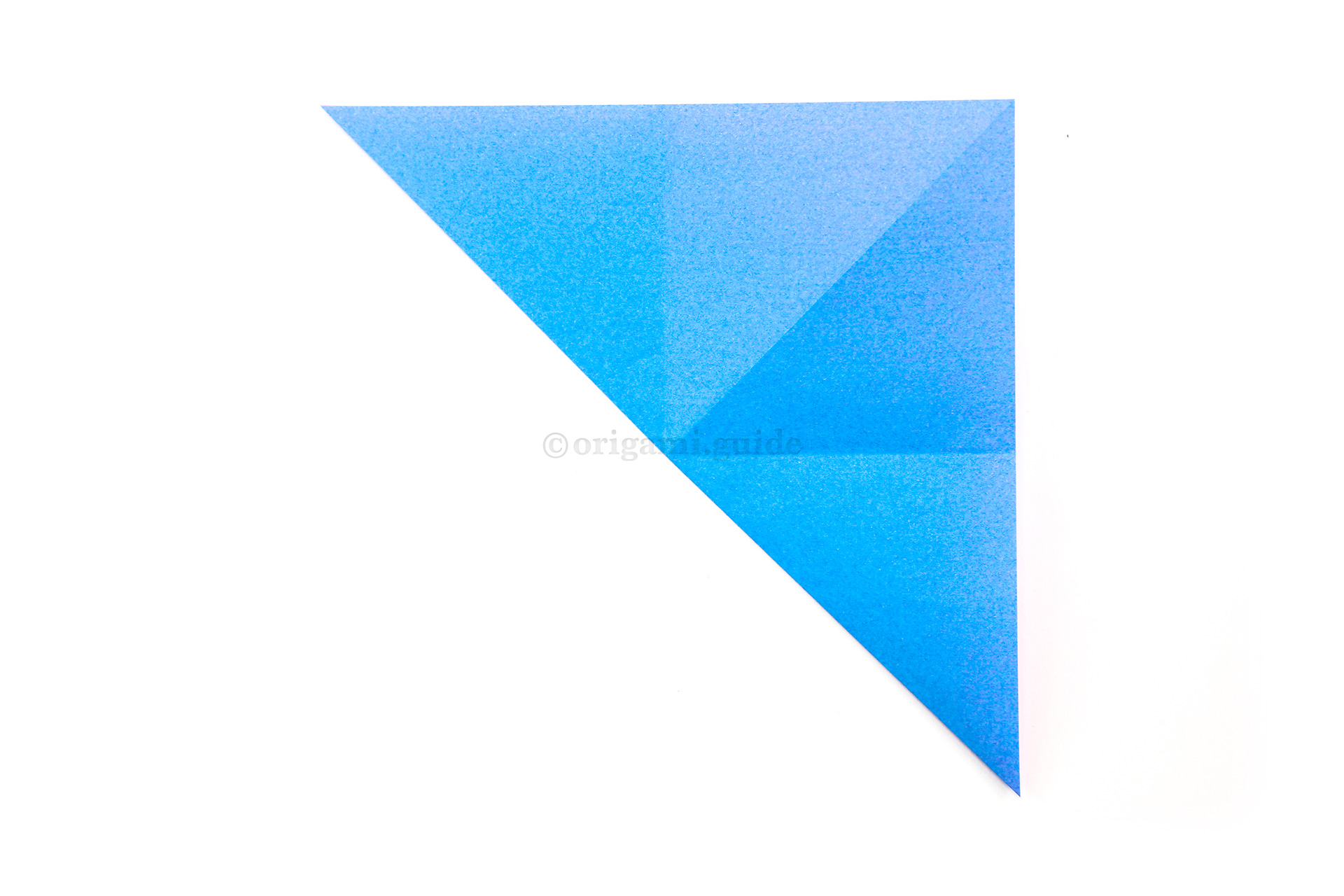 10. Fold the bottom left corner diagonally up to the top right corner.