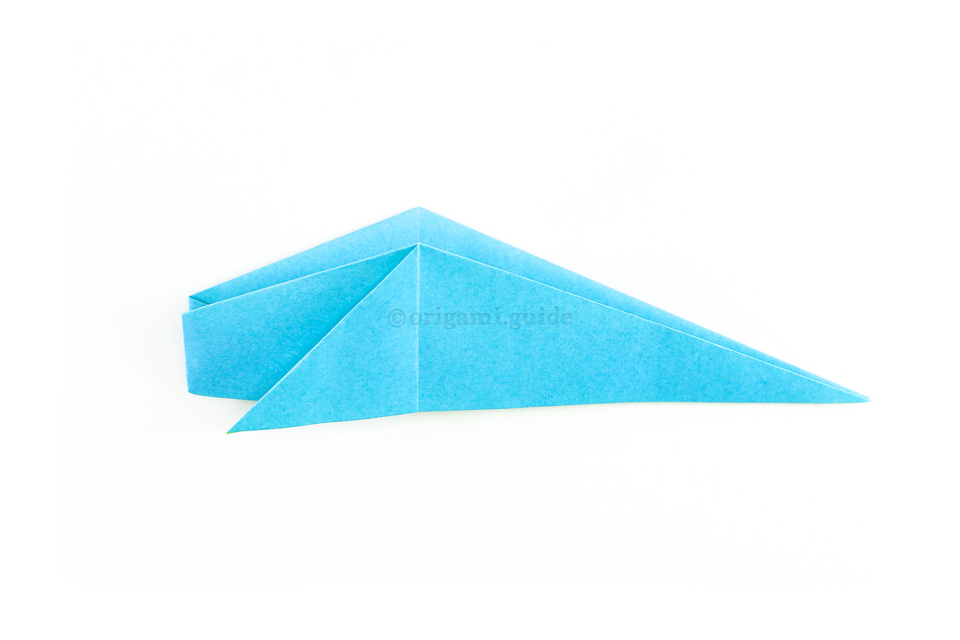Fold the bottom section up to the top, revealing the shape of the whale.