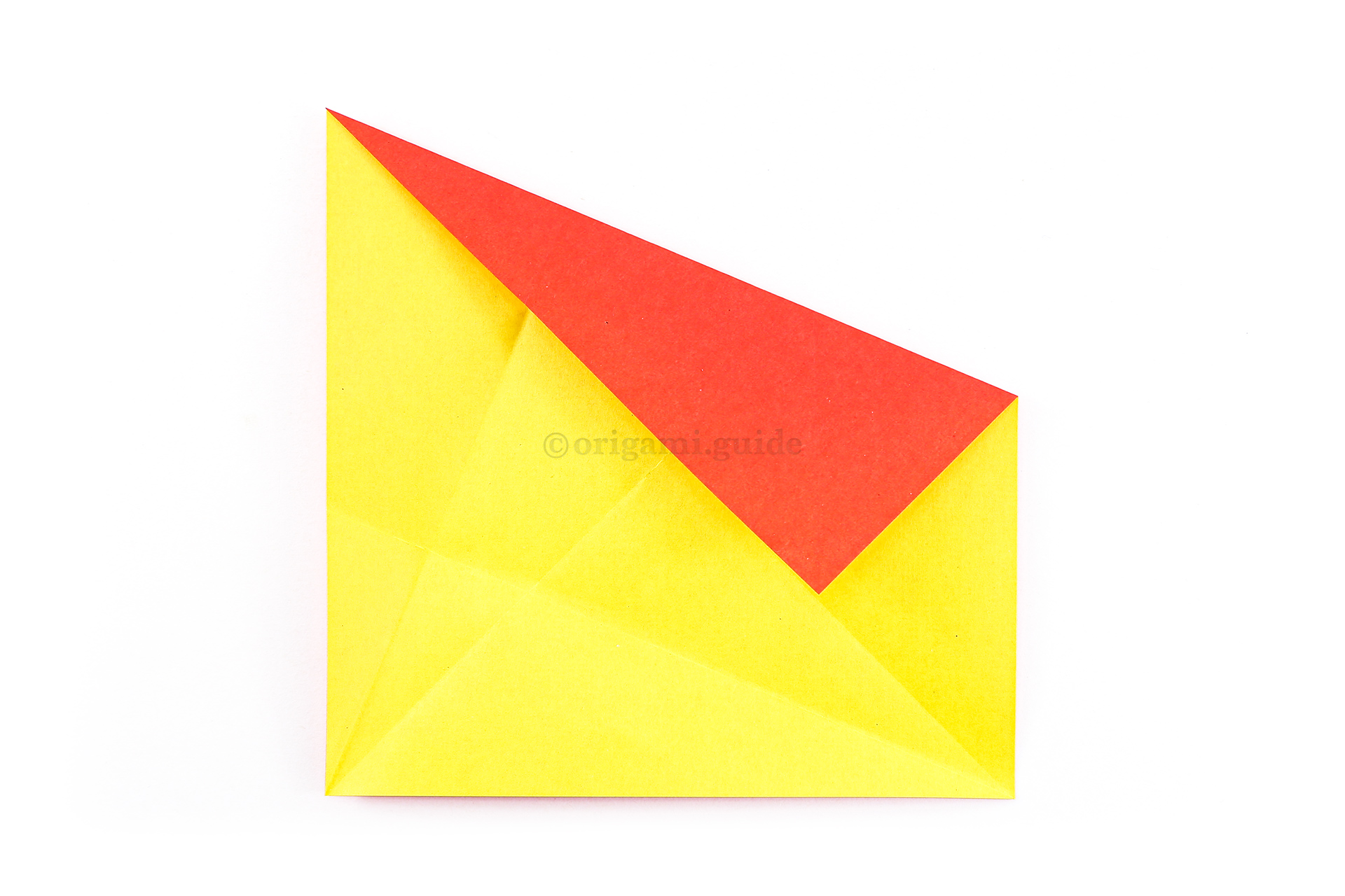 Fold the top right corner diagonally down to align with the central diagonal crease.