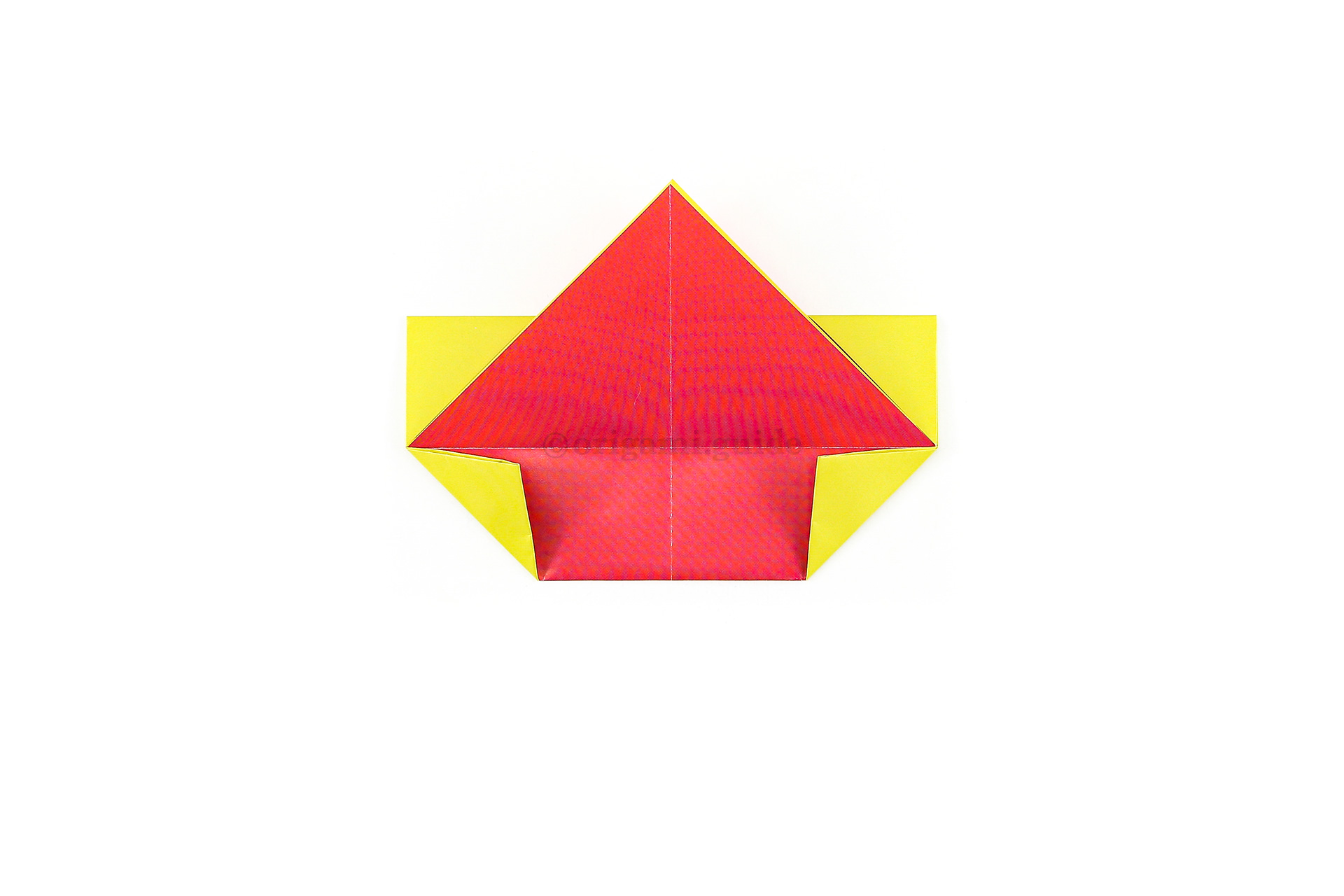 Fold the bottom left and right corners diagonally inward.