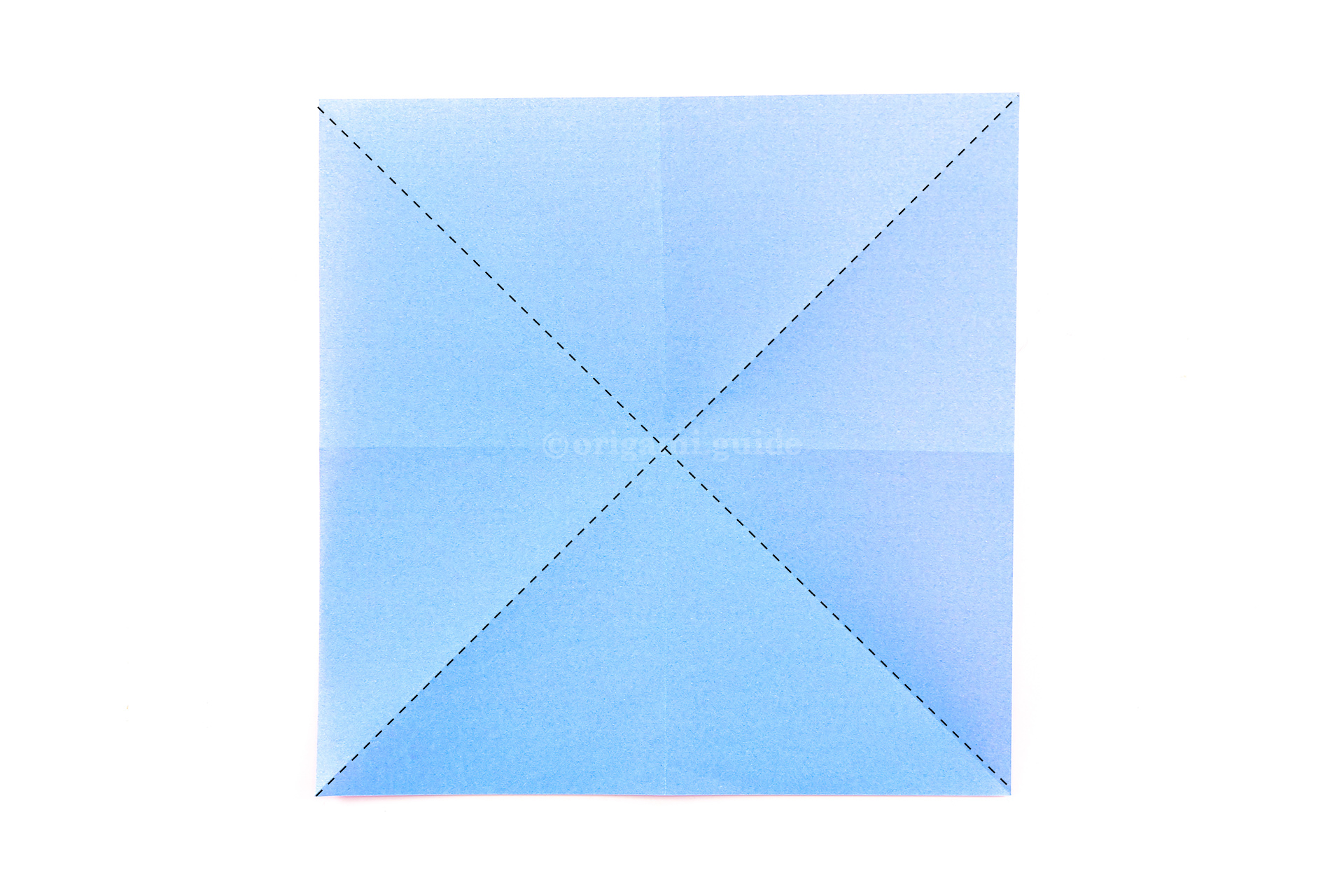 Flip the paper over to the other side. Fold the paper diagonally in both directions.
