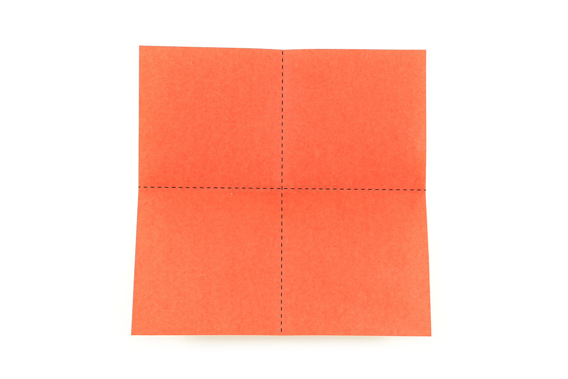 Fold the paper in half, from left to right. Then rotate the paper and repeat.