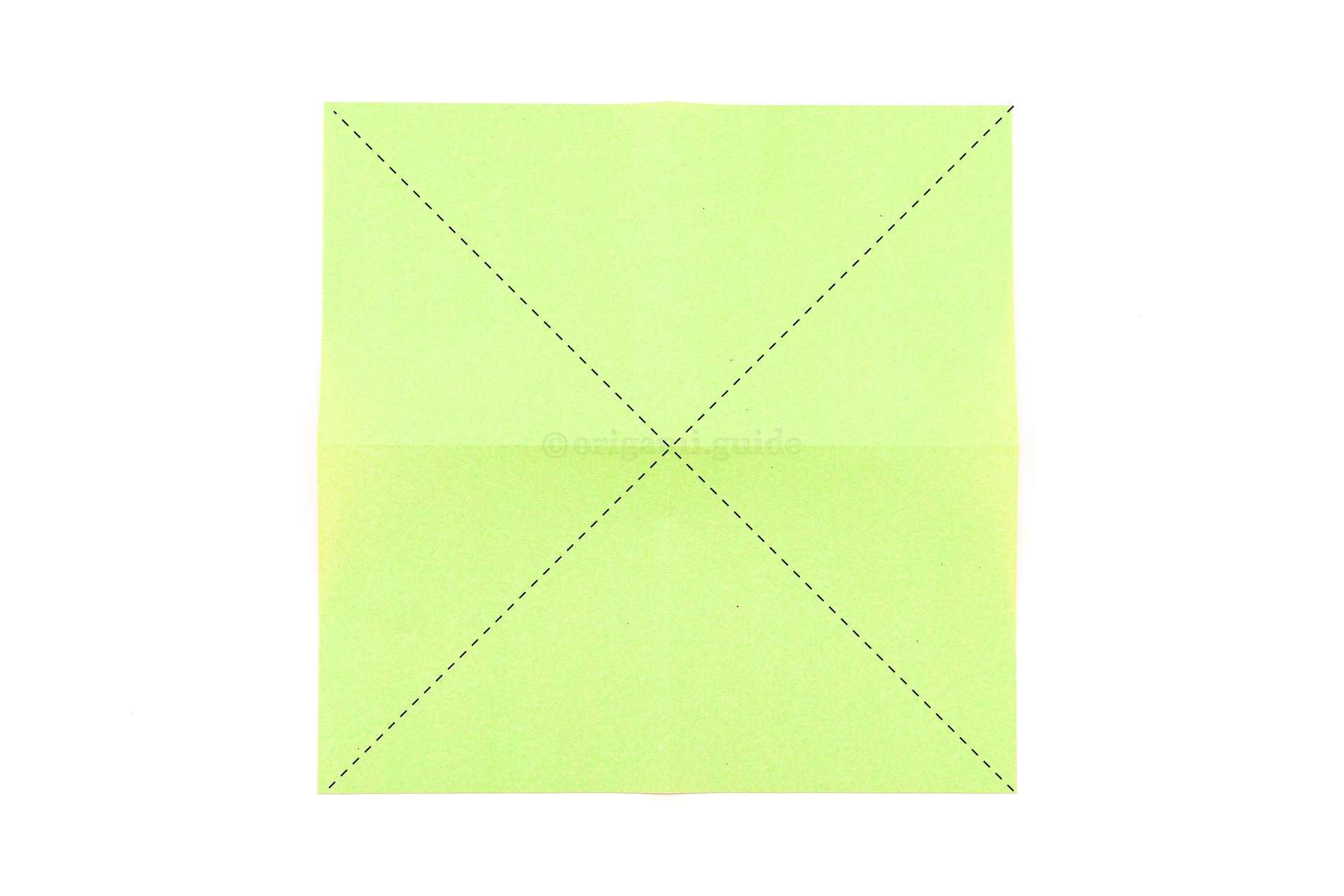 Flip the paper over to the other side. This time fold the two diagonals.