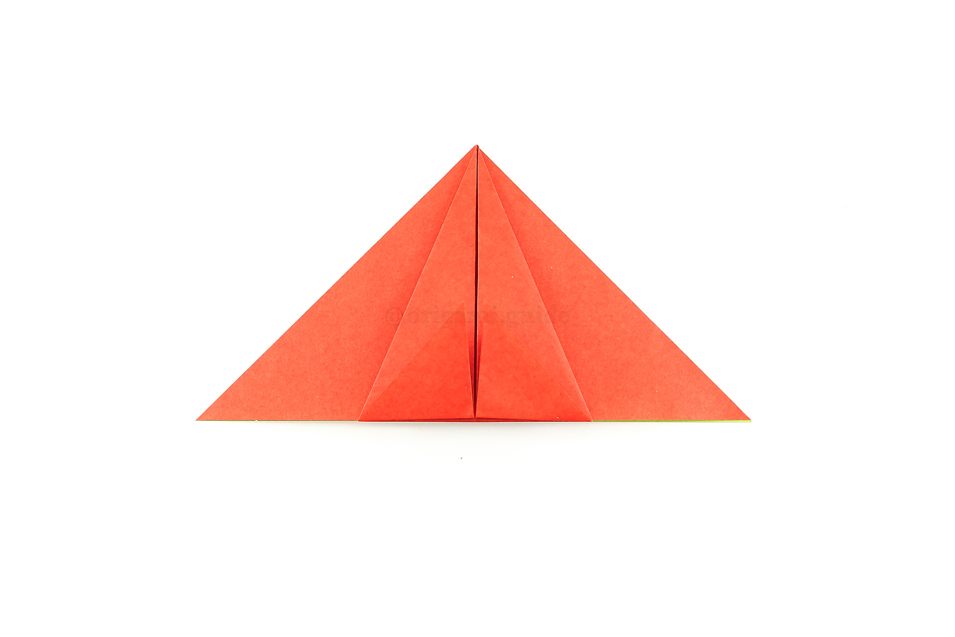 Next, fold the two lower flaps upward, aligning with the bottom edge of the triangle.