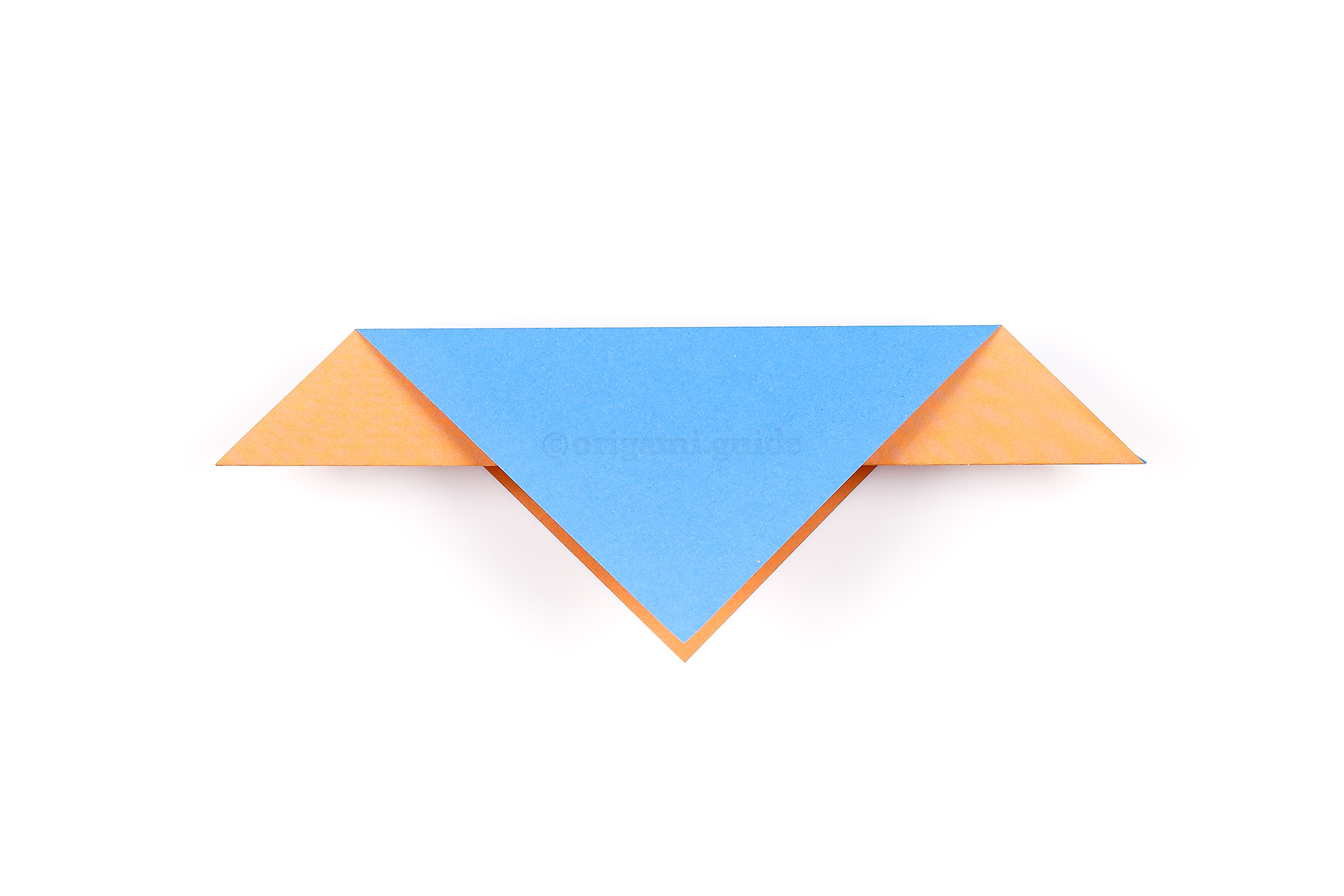 Fold the top triangular section down behind to match the front section.