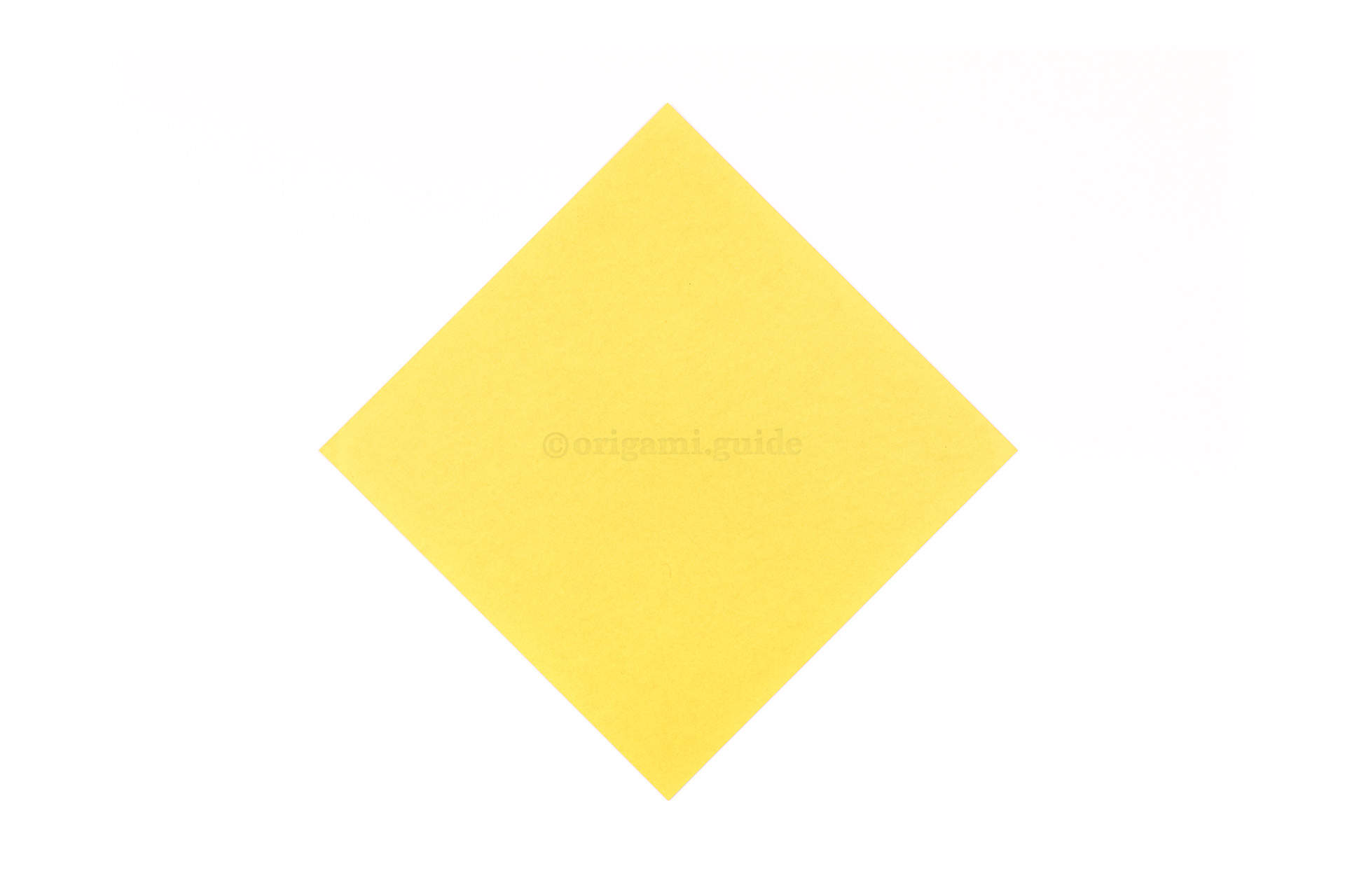 Now we will make the origami chick to go inside the egg. This is the front of our origami paper, the chick will end up being this colour.