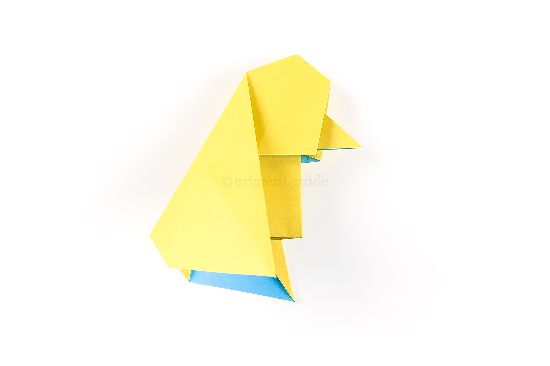 Flatten the paper back down, your little origami chick is complete.