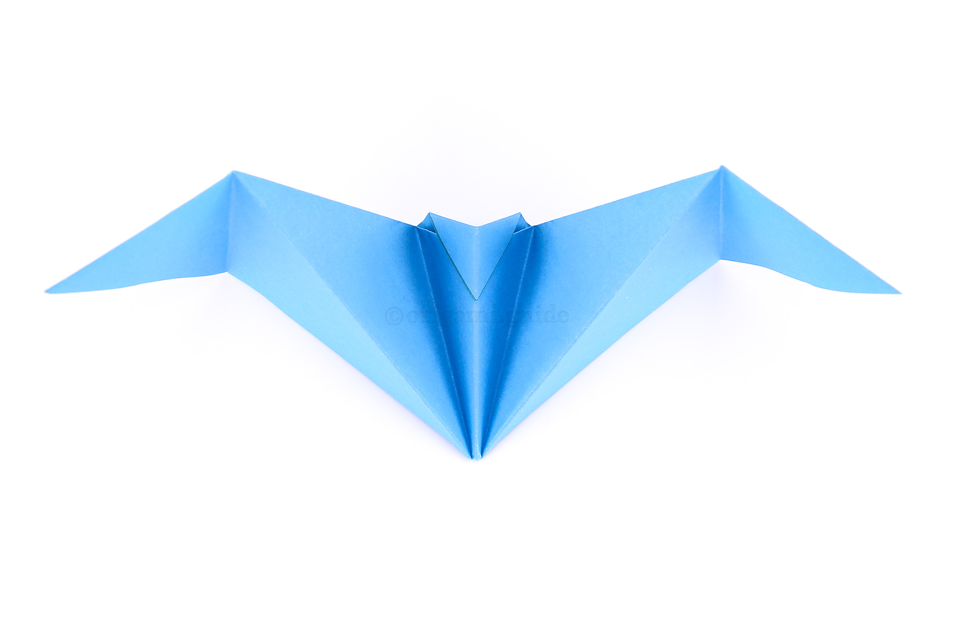 Pull the two wings apart gently, and ta-da! Your origami bat is all done.