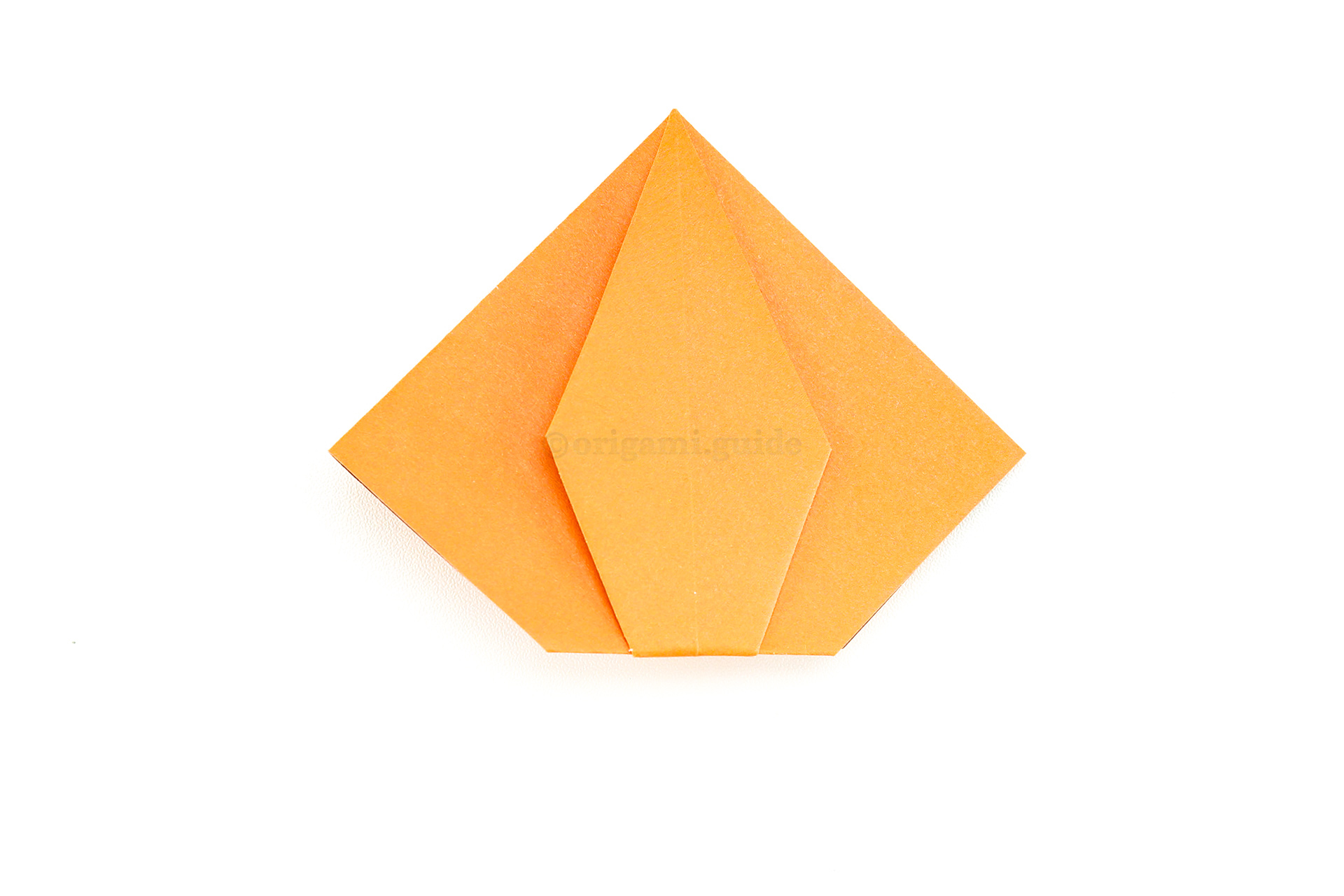 There are several ways to shape the pumpkin, so using your judgement, fold the bottom point behind to form the base of your origami pumpkin.