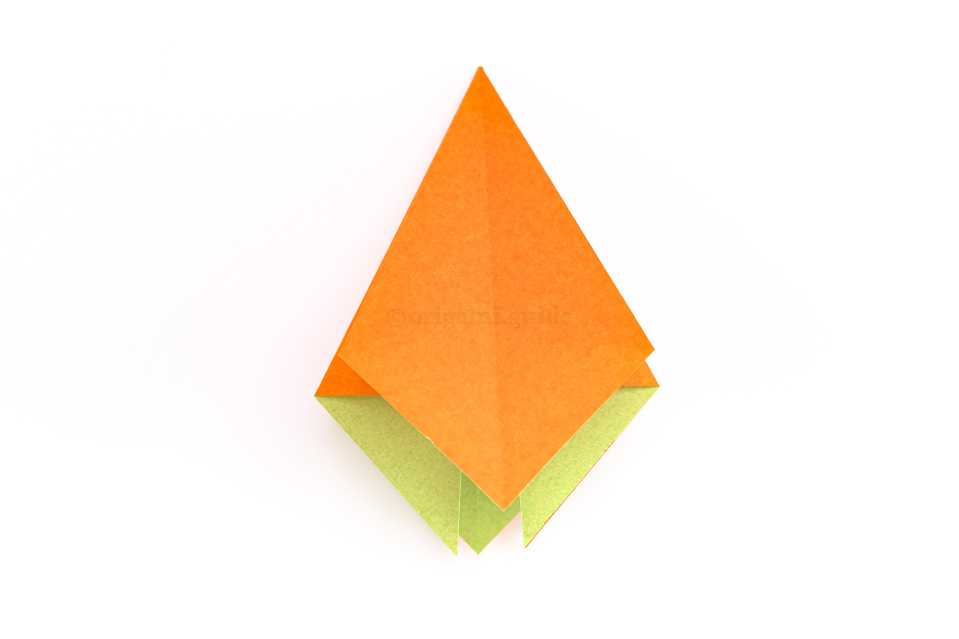 Step 23 - Flip the paper over and repeat the squash fold on the remaining three sections.
Position the paper so that you are looking at a plain side as shown.