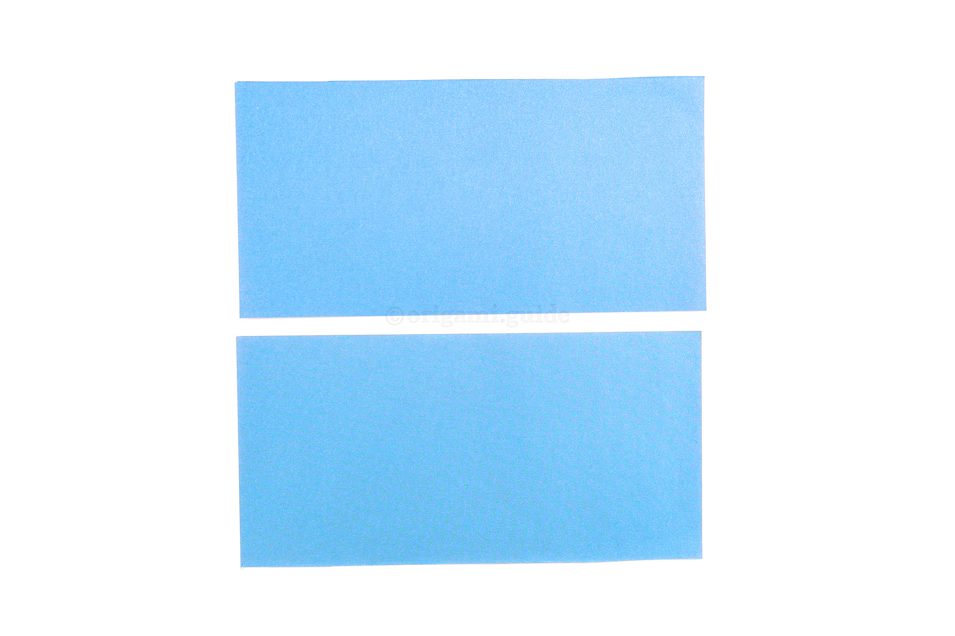 Step 41 - Cut along the crease. You now have enough paper to make two handles.