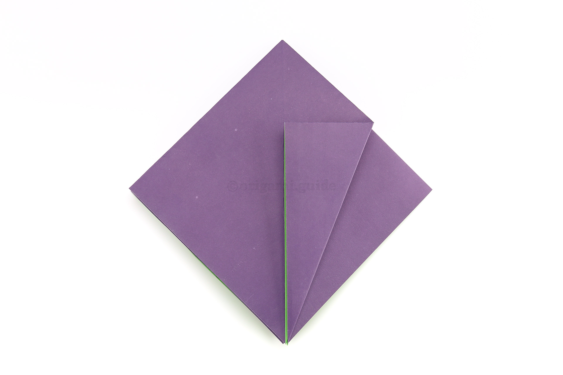Fold the lower right diagonal edge to the central crease.
