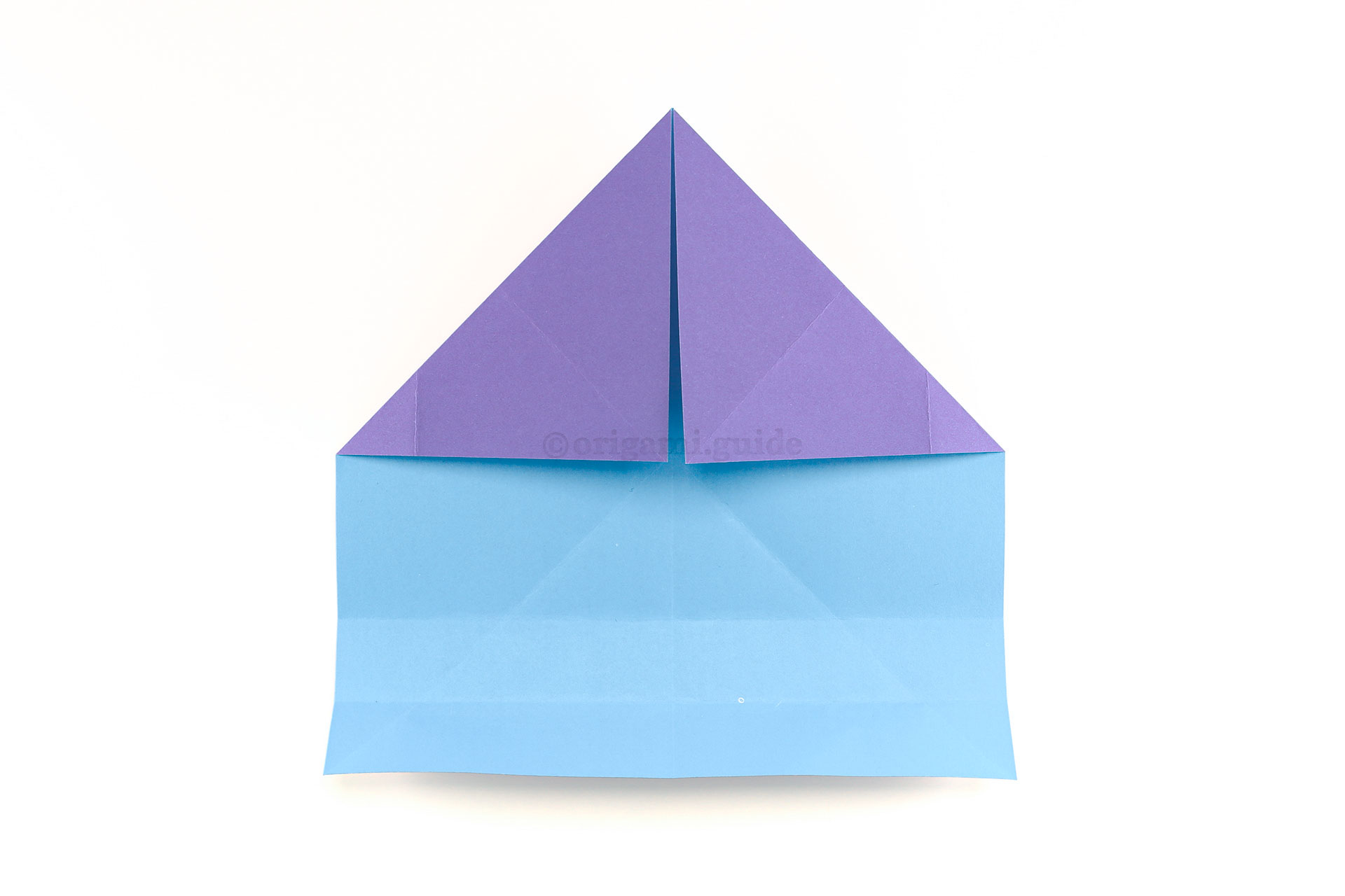 Step 15 - Unfold the last step, and then fold the top right and top left corners diagonally down as shown.
