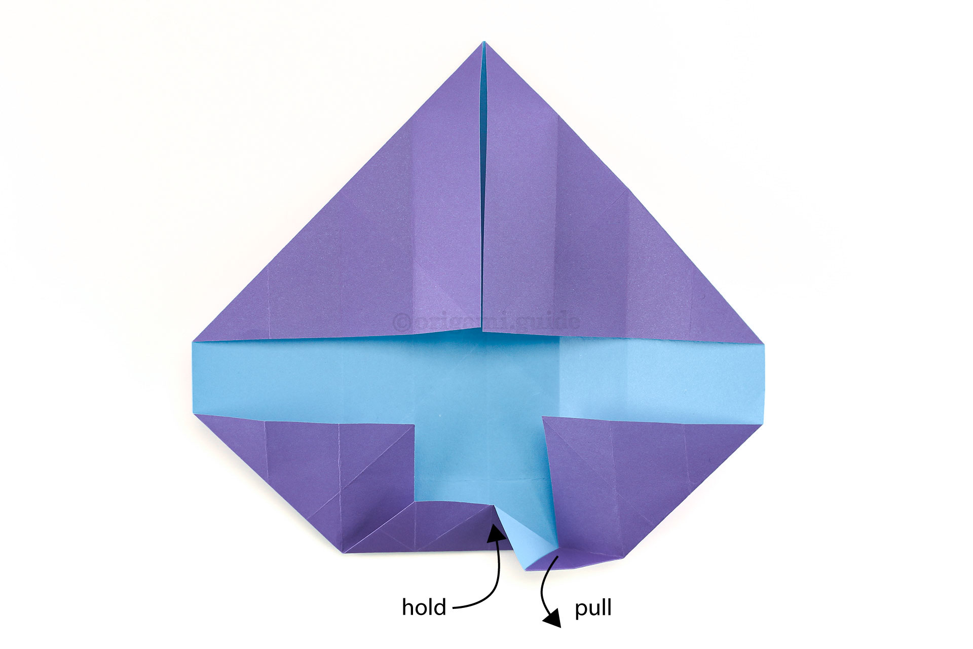 Step 25 - While holding the lower triangle section, pull out the corner indicated.