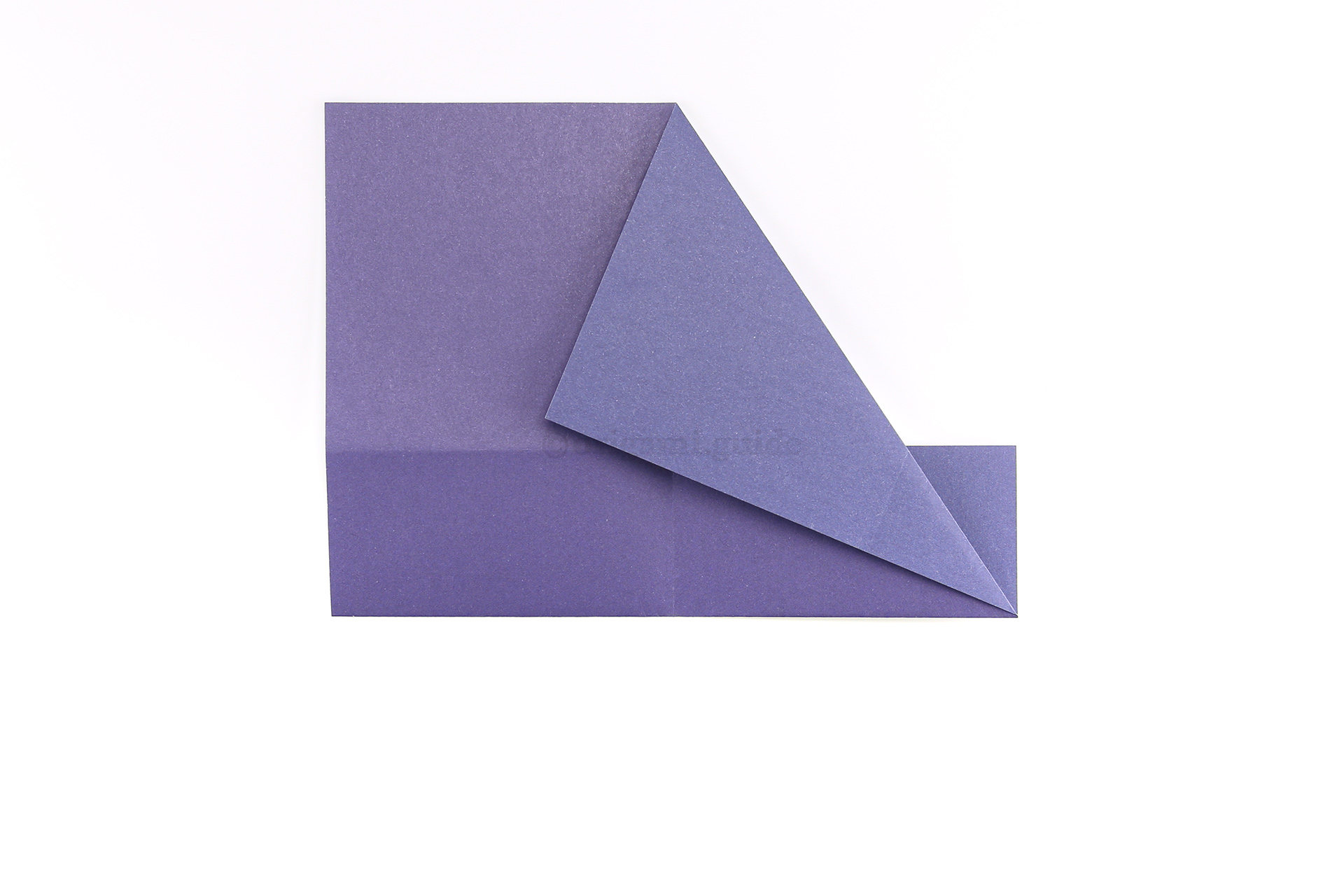 Step 8 - Take the top right corner and fold it diagonally down to the left, using the central crease as a guide.