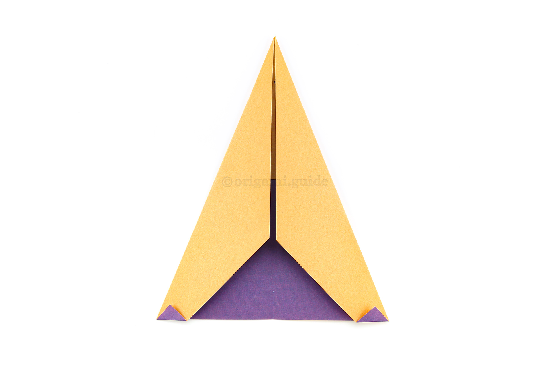 Step 8 - Fold the two lower points that overlap up, this creates the eyes.